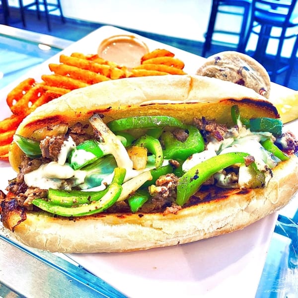 Knickerbockers Deli cheesesteak with green peppers, onions, waffle fries, and a cookie.